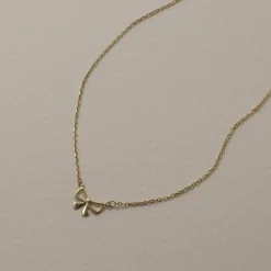 New Medley x Dinnara Micro Bow Necklace in 10k Gold Symbolic Jewellery | Necklaces & Pendants